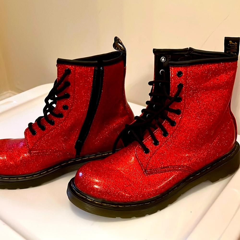 Dr. Martens orange glossy lace up combat boots.